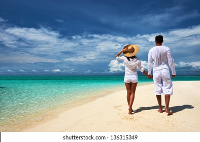 Couple On A Tropical Beach At Maldives