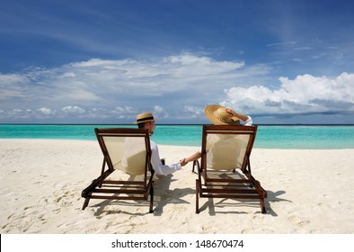 Couple on a tropical beach at Maldives - Shutterstock ID 148670474