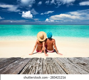 Couple On A Tropical Beach At Maldives