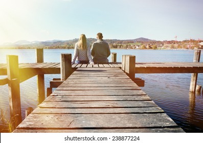 A Couple On The Wooden Jetty At A Lake