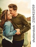 Couple, outdoor and kiss on cheek, love and bonding on date, smile and outing for anniversary in morning. Embrace, woman and man in vacation for celebration of marriage, honeymoon and commitment