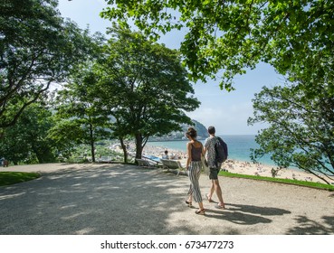 A Couple Overlooking Beach Of San Sebastian, SPain