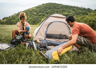 Couple pack equipment and theirs backpack after finish camp trip - Powered by Shutterstock