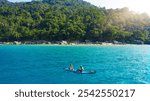 Couple, paddle board and sea on holiday, island and together for exercise, nature and drone for adventure. People, man and woman in summer with fun in tropical water, journey or ocean in Malaysia