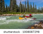 Couple paddling the whitewater of the Nahanni River in the Northwest Territories.