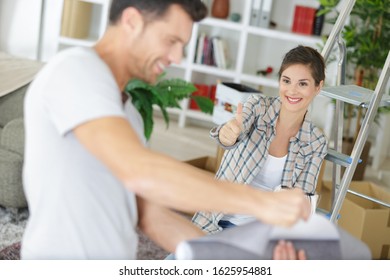 A Couple Painting Their House