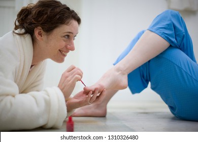 Couple Painting Toenails In House