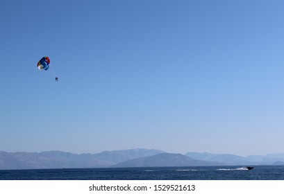 A Couple Paragliding In Ionian Sea At Corfu