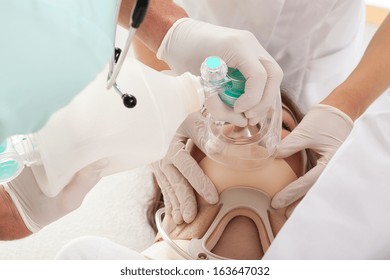 Couple of paramedics performing artificial respiration and resuscitation