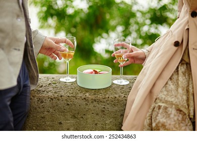 Couple In Paris, Eating Macaroons And Drinking Champagne