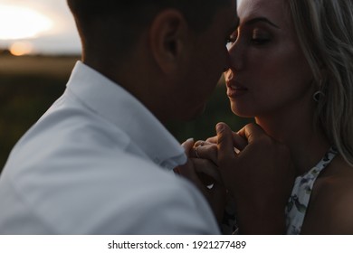 Couple passionately kissing at sunset. Man and woman silhouettes - Powered by Shutterstock