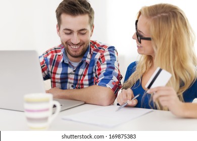 Couple Paying Bills By Credit Card 