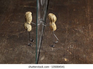 Couple Of Peanut People Being Kept Apart By A Glass Wall