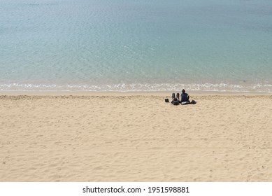 A Couple People Alone In The Sandy Beach, Roses, Alt Empordà, Catalonia, Spain