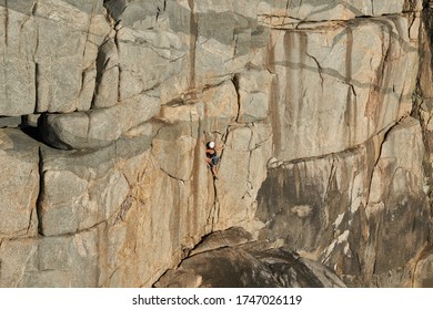 A Couple Of People Climbing On A Vertical Rock Without Protection