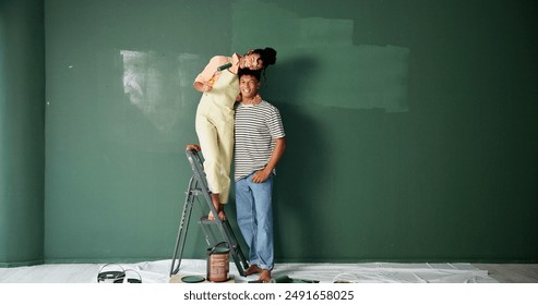 Couple, people and happy with painting wall for house renovations, upgrade and bonding. New home, relationship and smile for makeover for fun with support, care and teamwork for love with space - Powered by Shutterstock