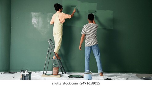 Couple, people and house wall or painting, roller and home renovation or together in new apartment. Teamwork, property project and diy or make over for relationship, love and back view with care - Powered by Shutterstock