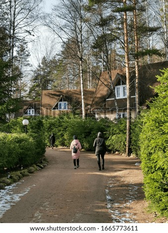 couple peoples walking in the park with house at sunny day