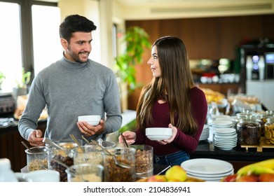 Couple picking food at a buffet in a hotel for his breakfast