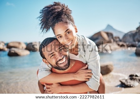 Couple, piggyback or bonding on beach by ocean, sea or rock pool water in Brazilian summer holiday. Portrait, smile or happy man carrying woman in fun activity, love or support trust in nature travel
