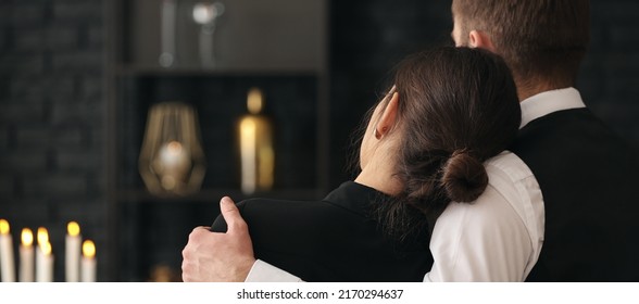 Couple pining after their relative at funeral - Shutterstock ID 2170294637