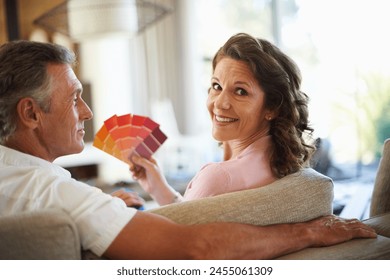 Couple, planning and color swatches for home renovation, project and portrait with palette in house. Mature, people and decision with paint options and discussion of interior design choice with ideas - Powered by Shutterstock