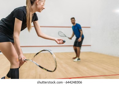 Couple play squash game in indoor training club