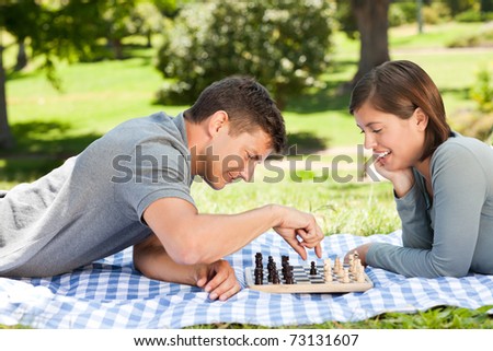 Couple playing chess in the park