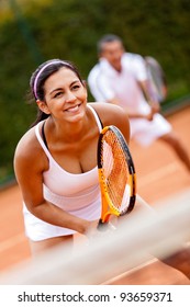 Couple playing doubles at the tennis court