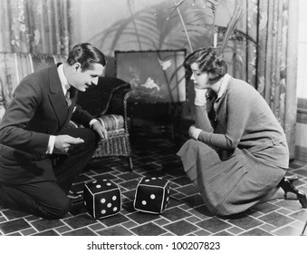 Couple Playing With Huge Dice