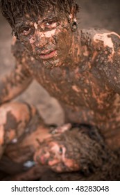 couple playing in the mud