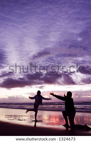 Couple playing on the beach
