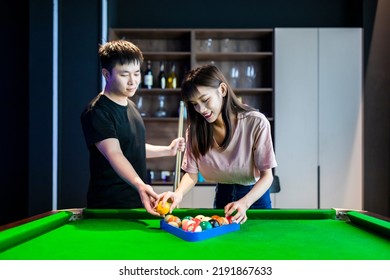 Couple Playing Pool In The Rec Room