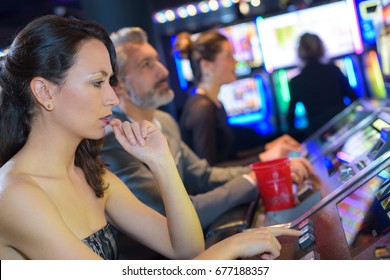 Couple Playing Together At Slot Machine