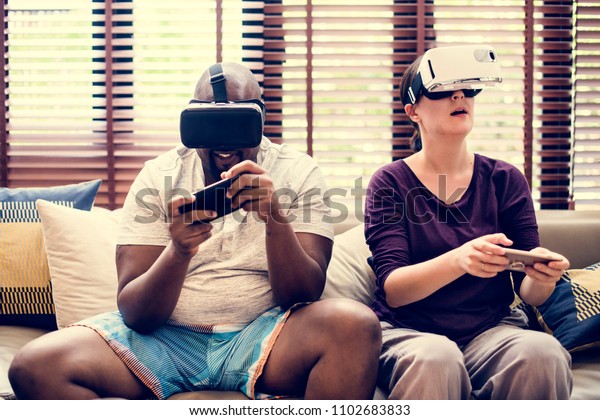 Couple playing VR video\
game