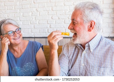 Couple And Portrait Of Two Happy Mature People Senior Eating In A Fast Food Or Restaurant Together Smiling And Having Fun Laughing - Happy And Cute Lifestyle And Concept Of Two Pensioners At Home