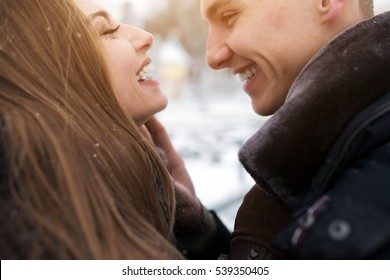 couple posing in a snowy park, close view
