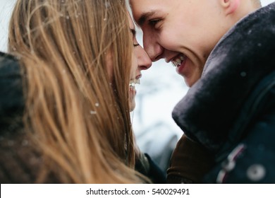 couple posing in a snowy park, close view