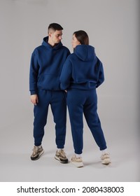 Couple Posing In Studio Wearing Blue Hoodie Costumes