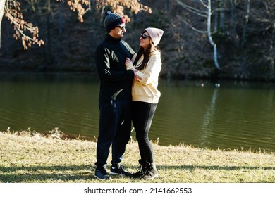 Couple In Pound At Early Spring Park.