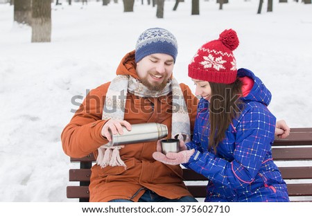couple pours tea in the winter