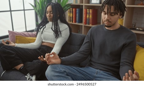 A couple practices mindfulness together in a cozy living room, reflecting peace, togetherness, and well-being. - Powered by Shutterstock