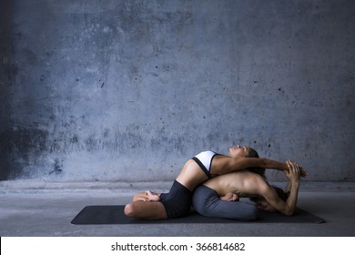 Couple practicing yoga together, passive stretch like thai massage
