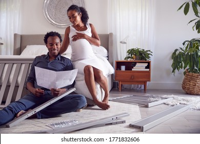 Couple With Pregnant Woman Looking At Instructions For Self Assembly Baby Cot - Powered by Shutterstock