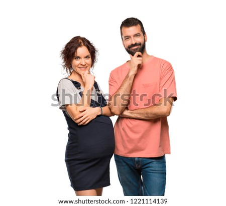 Couple with pregnant woman smiling and looking to the front with confident face on isolated white background