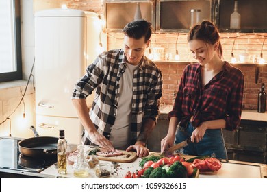 Couple Preparing To Receive Guests Cooking Meat And Salt