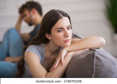 Couple Quarrel. Young Woman Sit Looking Upset After A Bad Talk With Her Husband