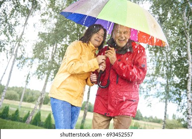 Couple With A Rainbow Umbrella