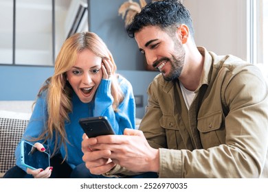 Couple Reacting Excitedly to Something on Their Smartphones - Powered by Shutterstock