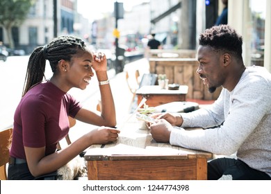 Couple reading the menu at a cafe